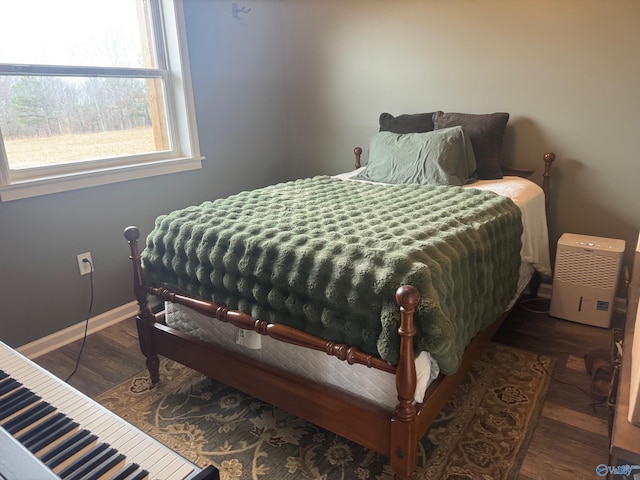 bedroom with dark hardwood / wood-style flooring