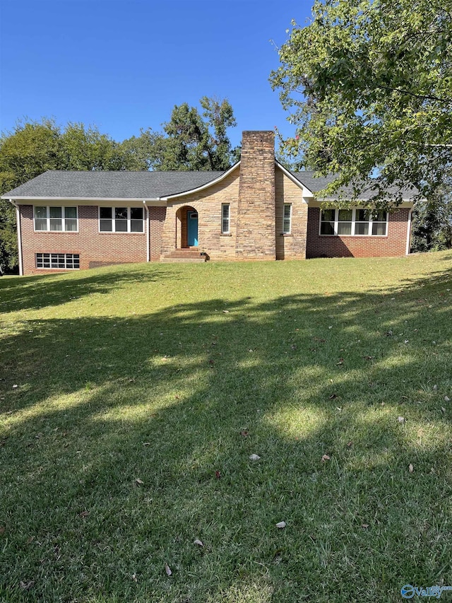 single story home featuring a front lawn, brick siding, and a chimney