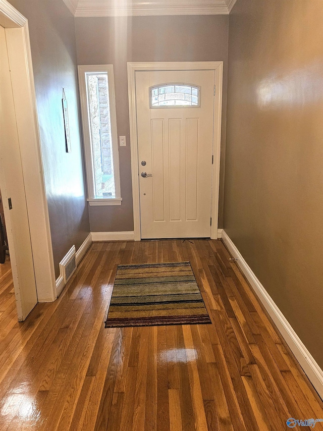 entryway with crown molding, baseboards, and hardwood / wood-style floors