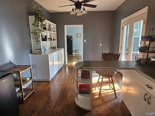 kitchen with dark wood finished floors, open shelves, a ceiling fan, and tile counters