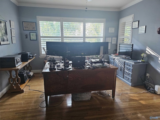 home office with a wealth of natural light, baseboards, crown molding, and light wood finished floors