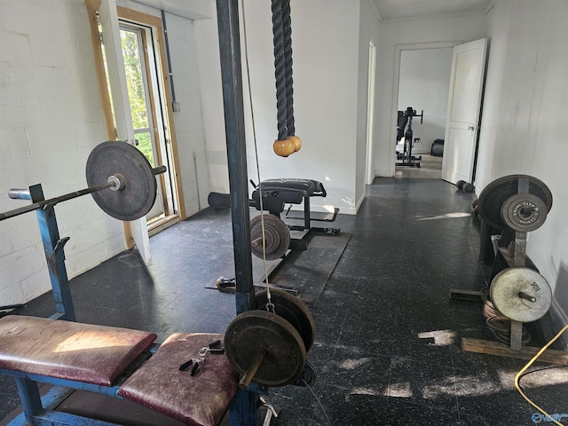 workout area featuring concrete block wall