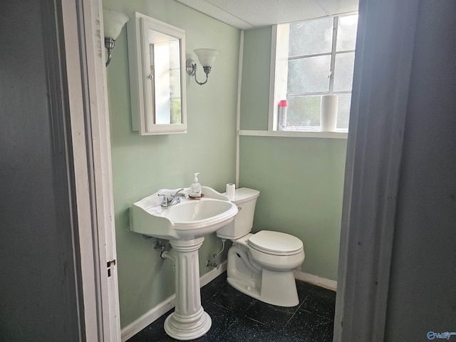 bathroom with tile patterned floors, toilet, and baseboards