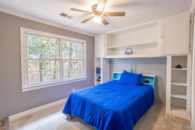 bedroom featuring ceiling fan, crown molding, and light colored carpet