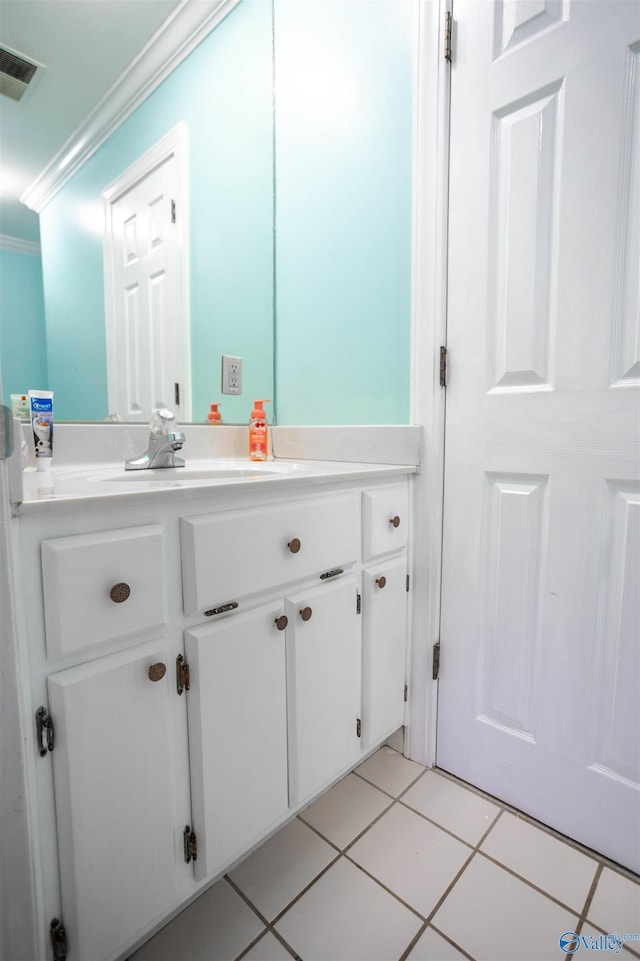 bathroom featuring tile patterned floors, vanity, and ornamental molding