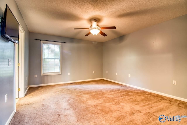 spare room featuring baseboards, carpet floors, and a ceiling fan