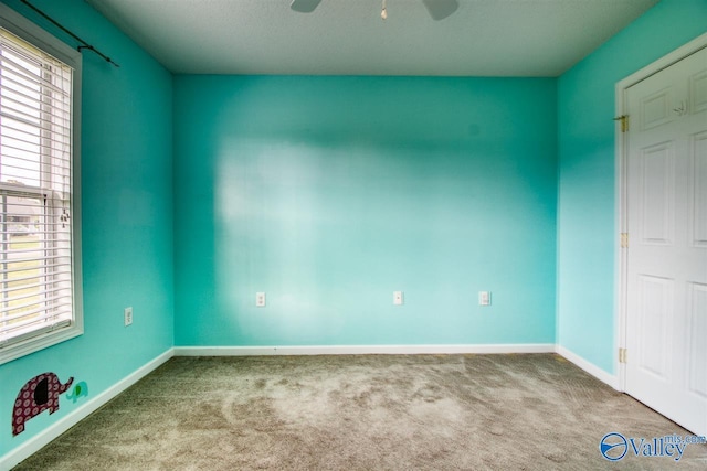 unfurnished bedroom with a ceiling fan, baseboards, and carpet floors