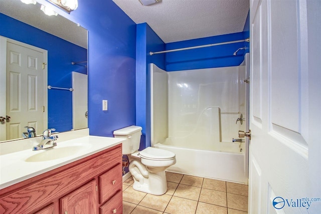 full bath featuring tile patterned flooring, washtub / shower combination, toilet, vanity, and a textured ceiling