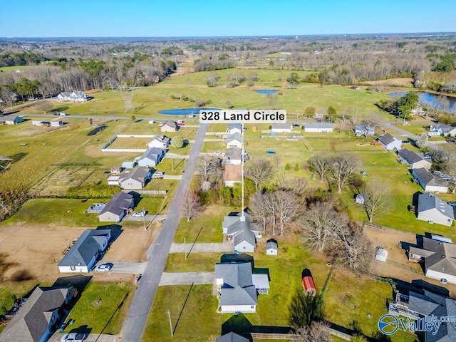 drone / aerial view with a residential view and a water view