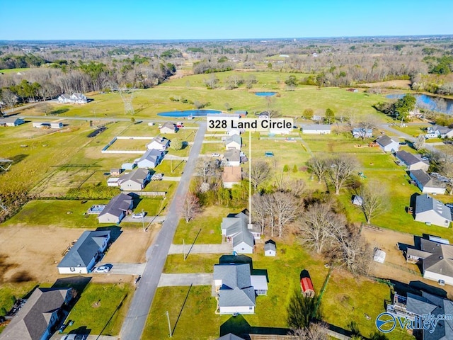 birds eye view of property with a residential view and a water view