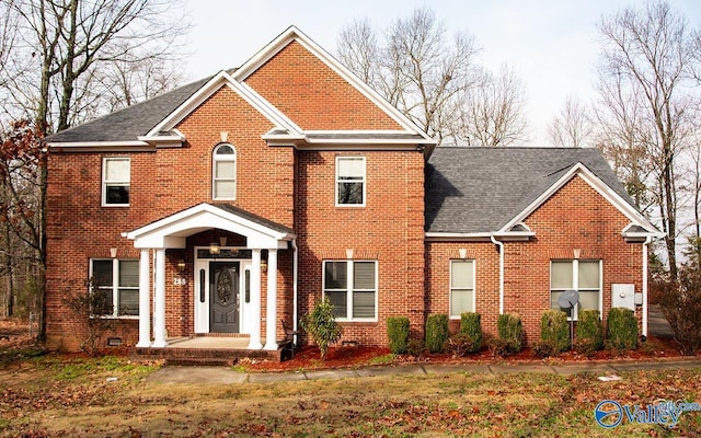 view of front of property featuring roof with shingles and brick siding