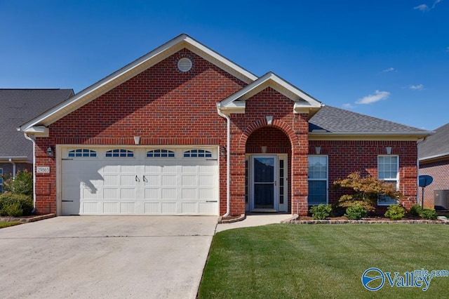 view of front of property featuring a garage and a front lawn