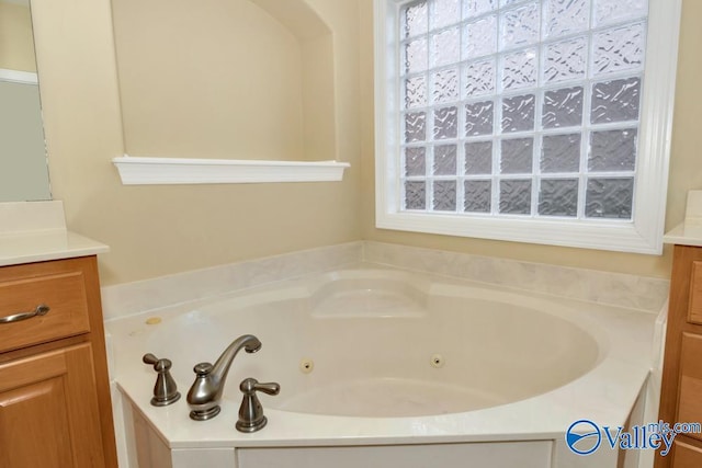 bathroom featuring a tub to relax in and vanity