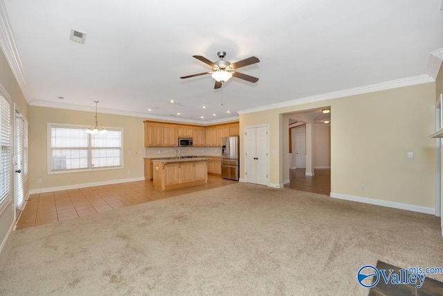 unfurnished living room featuring ceiling fan with notable chandelier, sink, crown molding, and light colored carpet