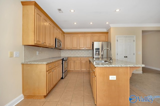 kitchen with tasteful backsplash, a kitchen island with sink, appliances with stainless steel finishes, light stone counters, and light tile patterned floors