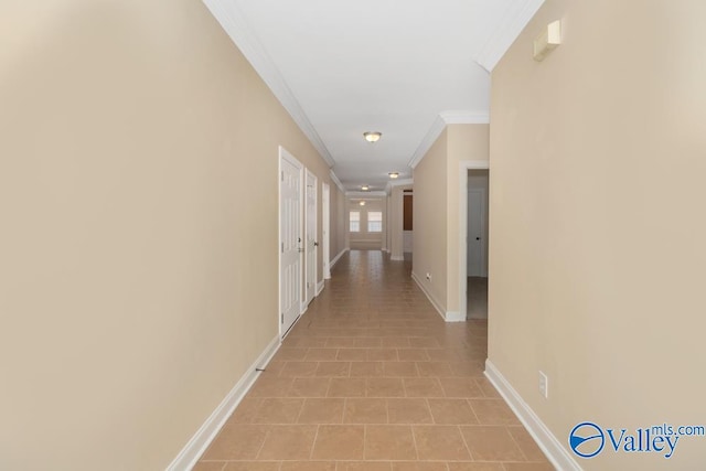 hall with light tile patterned floors and ornamental molding