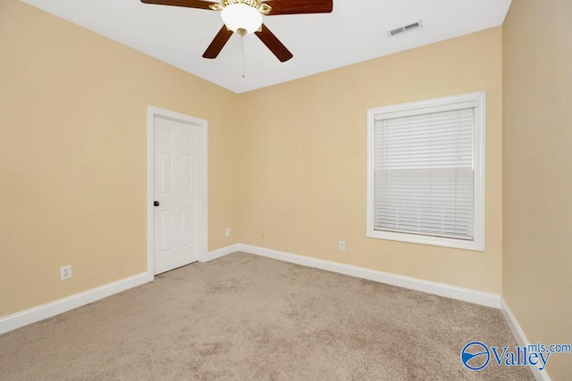 carpeted empty room featuring ceiling fan