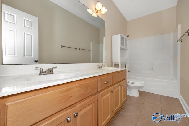 full bathroom featuring washtub / shower combination, tile patterned floors, toilet, and vanity