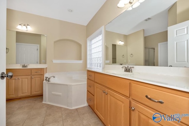 bathroom with tile patterned flooring, separate shower and tub, and vanity