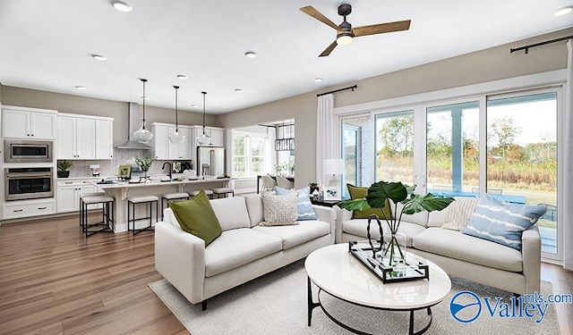 living room featuring wood finished floors, recessed lighting, and a ceiling fan