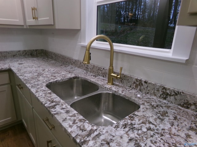 room details with light stone countertops and sink