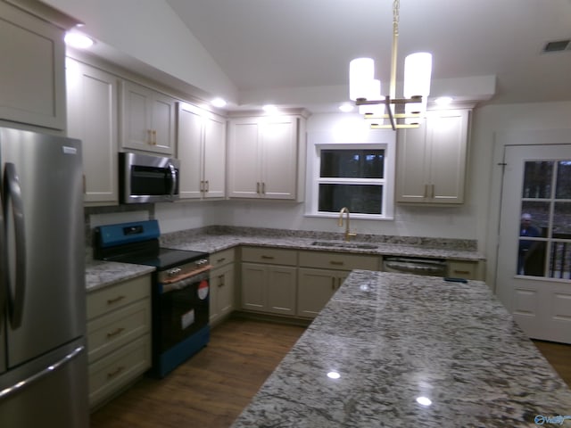 kitchen with sink, dark hardwood / wood-style floors, a chandelier, vaulted ceiling, and appliances with stainless steel finishes