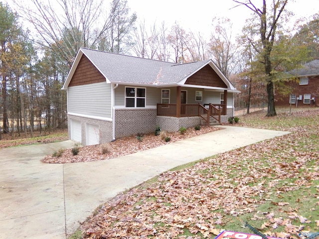 ranch-style home featuring covered porch and a garage