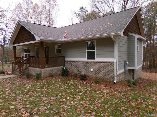 view of front of house with a front yard and a porch