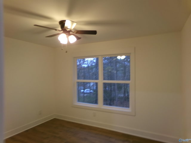 spare room featuring ceiling fan and dark hardwood / wood-style floors