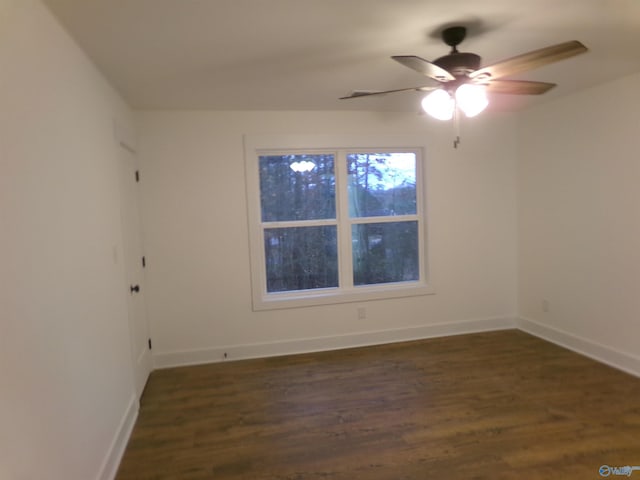 empty room featuring ceiling fan and dark wood-type flooring