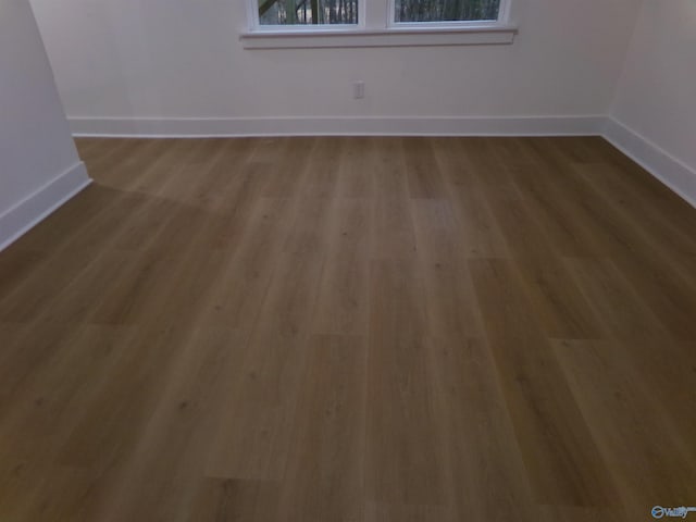 spare room featuring hardwood / wood-style floors and plenty of natural light