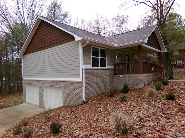 view of property exterior with a porch and a garage