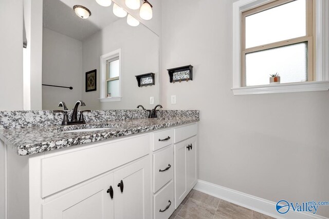 112 Elledge Farm Dr, Hazel Green, AL 35750 - bathroom with baseboards, double vanity, and tile patterned flooring