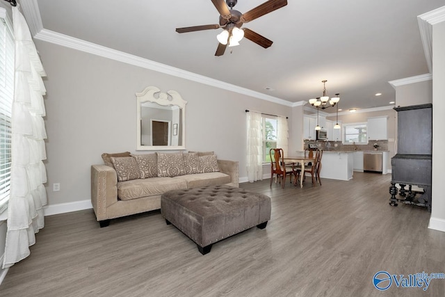 112 Elledge Farm Dr, Hazel Green, AL 35750 - living area featuring ceiling fan, a chandelier, baseboards, ornamental molding, and light wood-style flooring
