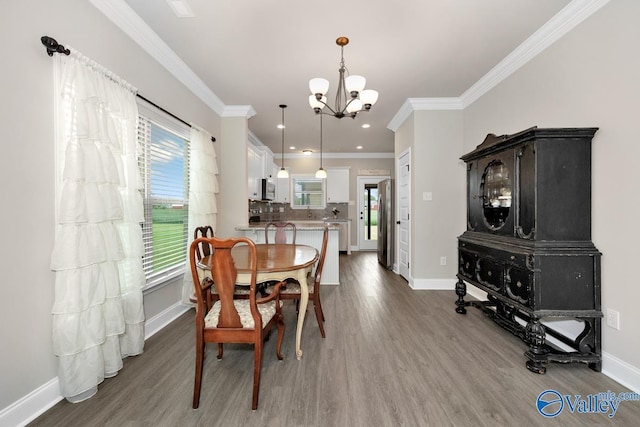 112 Elledge Farm Dr, Hazel Green, AL 35750 - dining area with a chandelier, wood finished floors, baseboards, ornamental molding, and recessed lighting