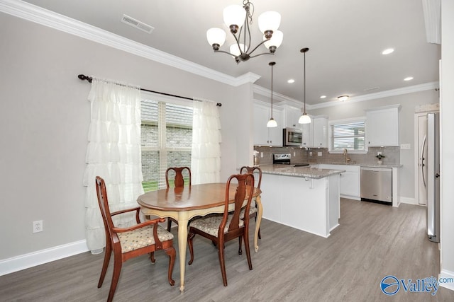 112 Elledge Farm Dr, Hazel Green, AL 35750 - dining area with a chandelier, light wood finished floors, ornamental molding, baseboards, and recessed lighting