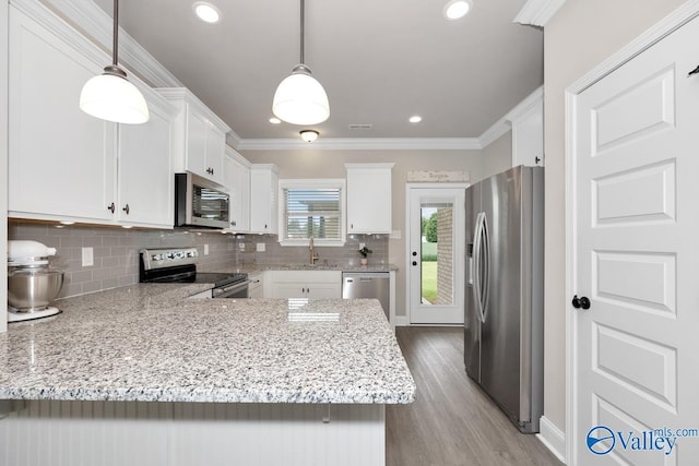 112 Elledge Farm Dr, Hazel Green, AL 35750 - kitchen with stainless steel appliances, a peninsula, white cabinets, backsplash, and crown molding