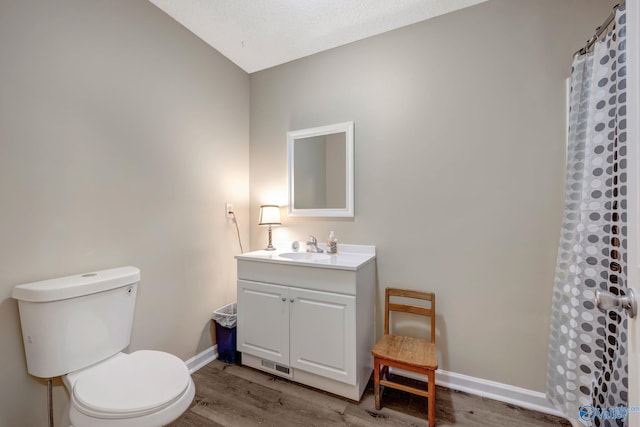 bathroom featuring vanity, lofted ceiling, hardwood / wood-style flooring, toilet, and a shower with curtain