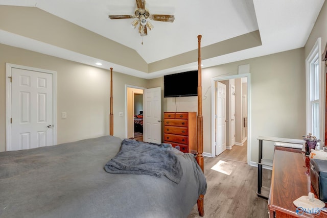 bedroom with light hardwood / wood-style floors, lofted ceiling, and ceiling fan