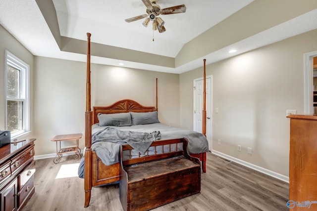 bedroom featuring ceiling fan, lofted ceiling, and hardwood / wood-style floors