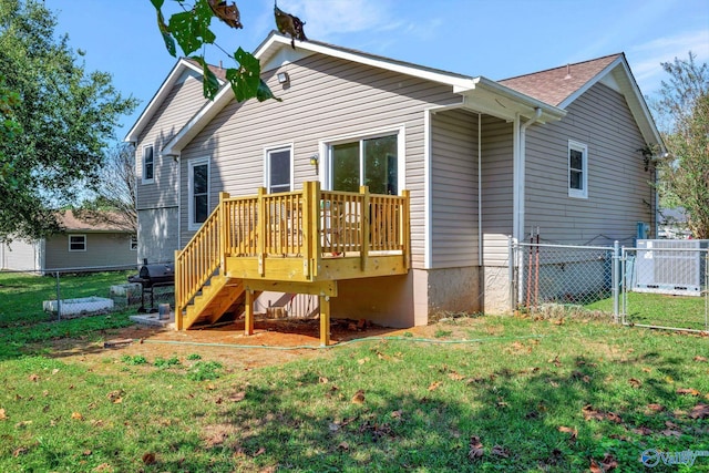 back of property featuring a wooden deck, cooling unit, and a yard