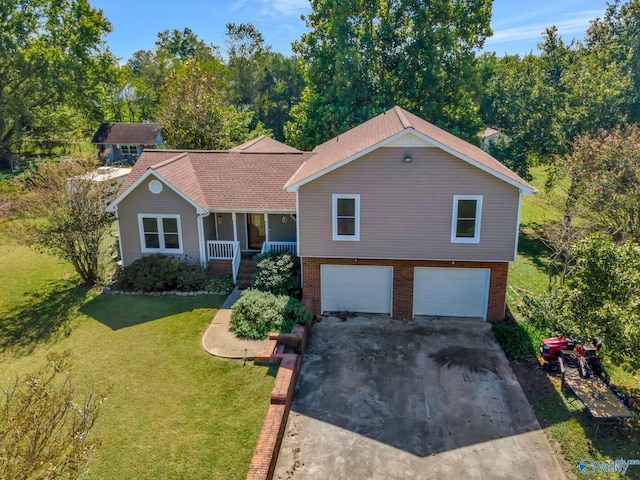 view of front of home featuring a front yard, a porch, and a garage