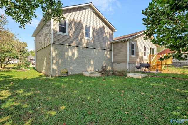 rear view of house with a yard