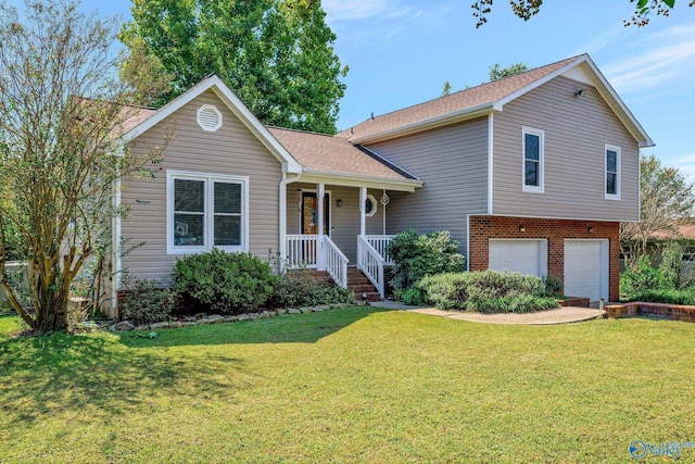 view of front facade with a garage, covered porch, and a front yard