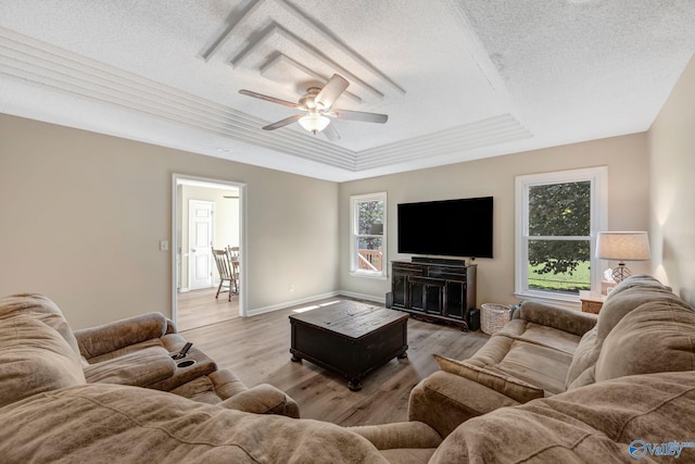 living room featuring a textured ceiling, ceiling fan, and light hardwood / wood-style flooring