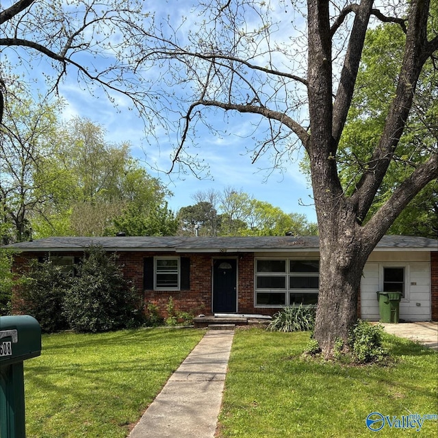 ranch-style home with brick siding and a front yard