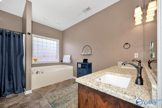 full bath with a sink, visible vents, vaulted ceiling, a bath, and double vanity