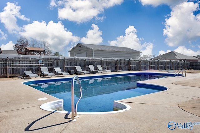 pool featuring a patio and fence