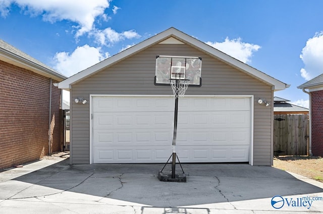 detached garage featuring fence