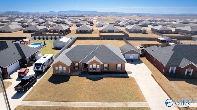 drone / aerial view featuring a residential view and a mountain view